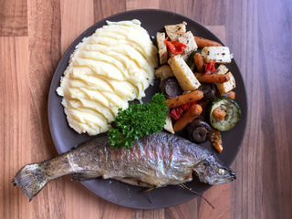 Baked fresh fish with vegetables and mashed potatoes